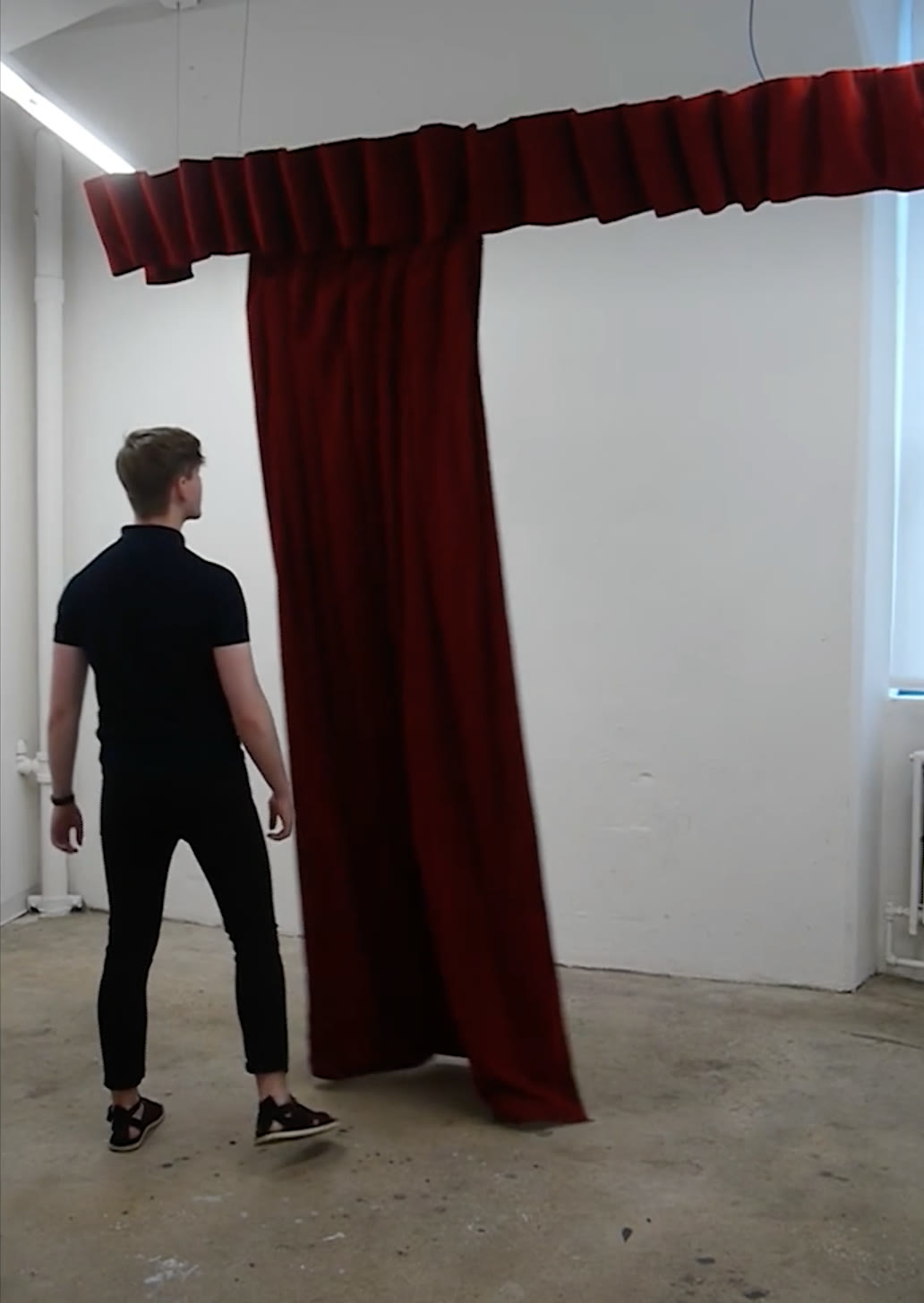 A visitor standing beside the curtain as it tracks his position